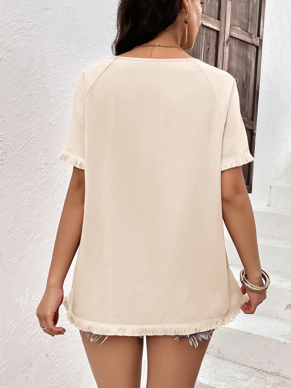 Cream fringe trim raglan sleeve top back view on model