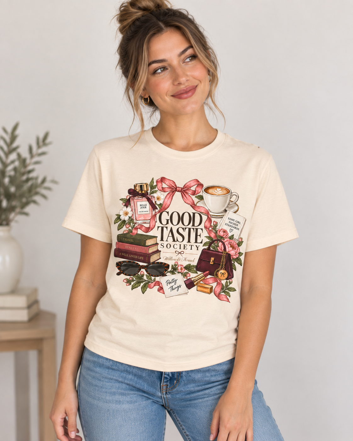 Feminine Good Taste Society graphic tee with coffee cup, books, bows, flowers, perfume and boutique accessories