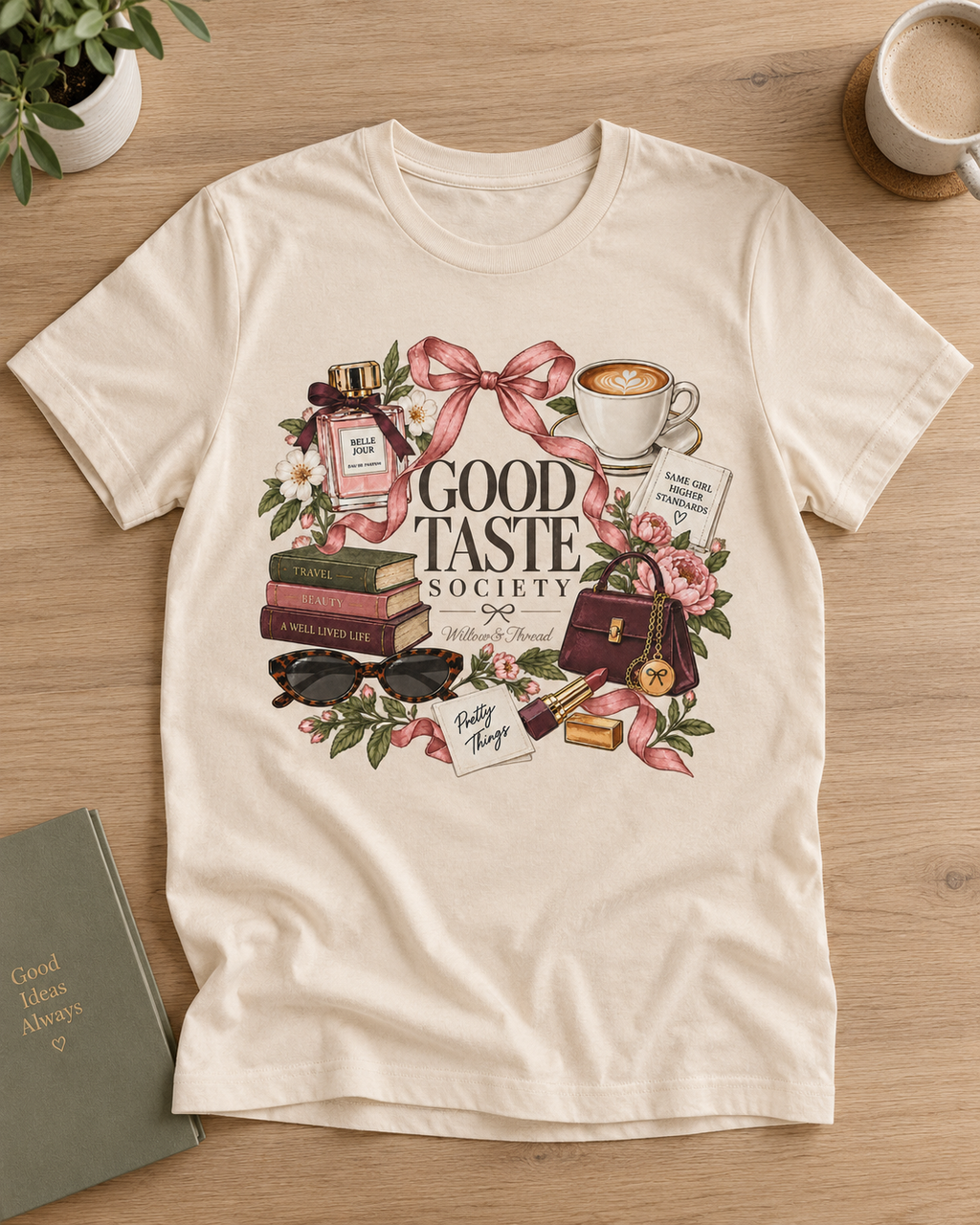 Good Taste Society boutique graphic tee for women with coffee, books, perfume, flowers and bow details