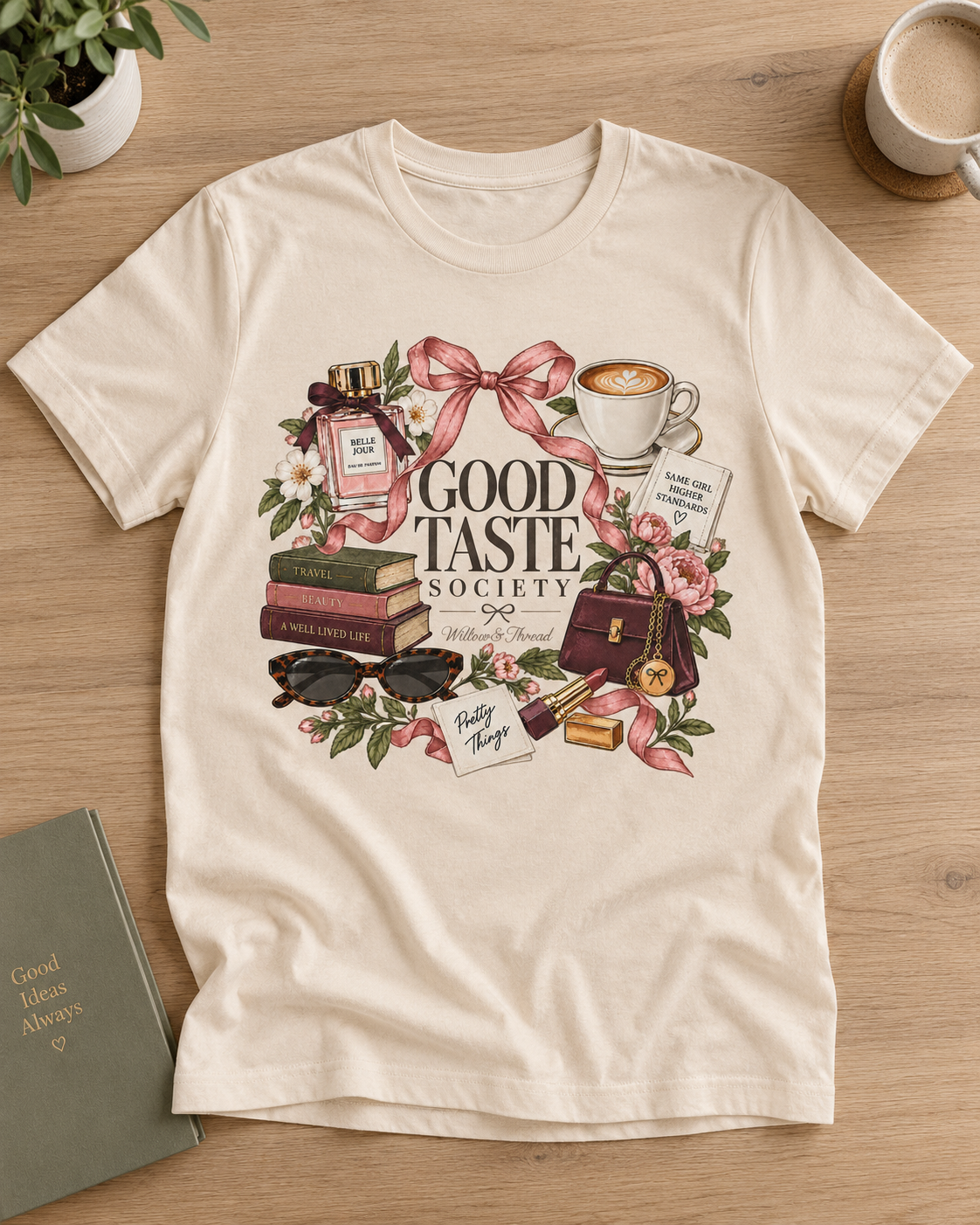 Good Taste Society boutique graphic tee for women with coffee, books, perfume, flowers and bow details