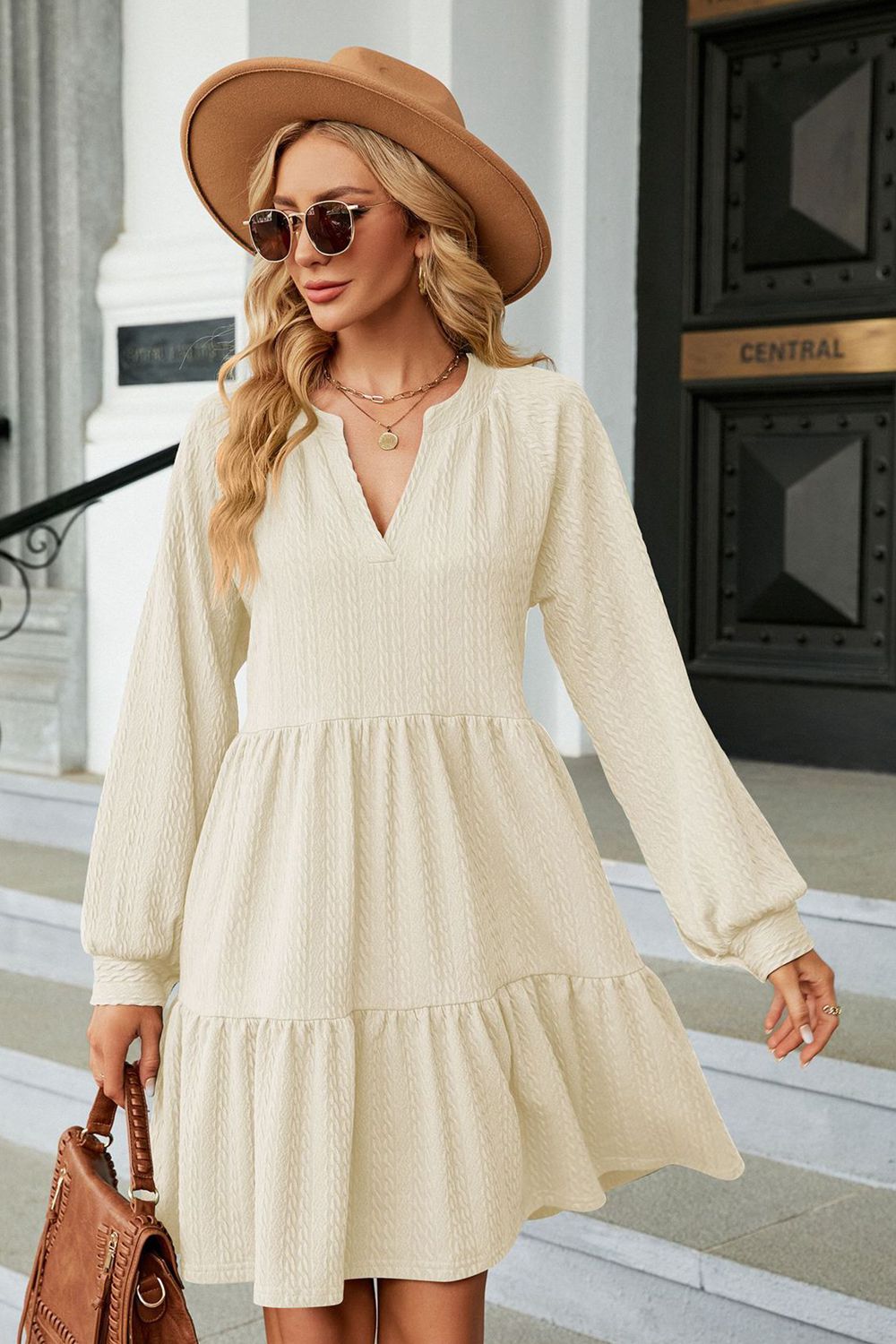 Cream notched neck long sleeve mini dress on model