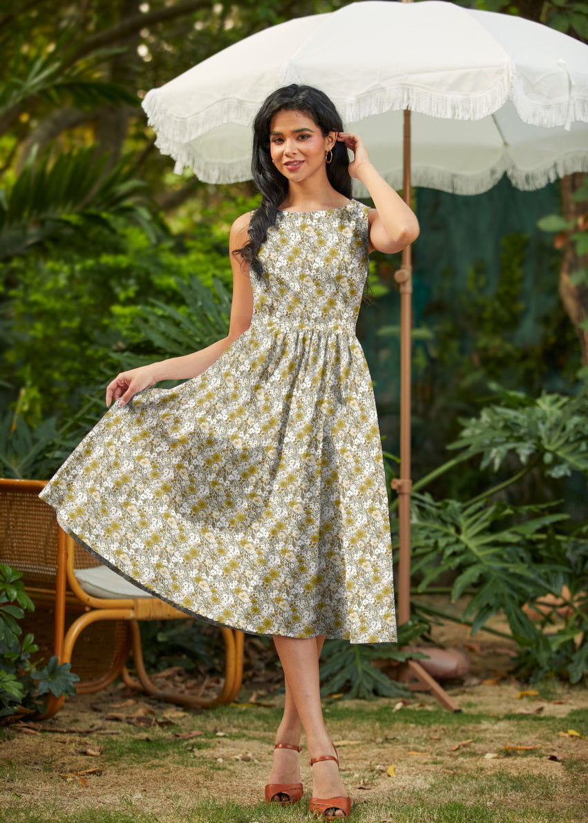 Alternate model pose in mustard floral midi dress holding a white umbrella