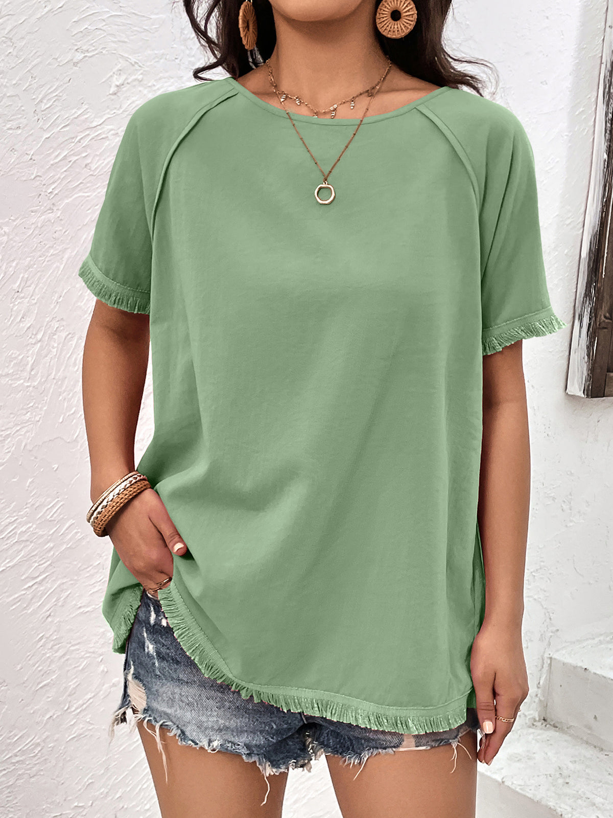 Light green fringe trim raglan sleeve top front view on model