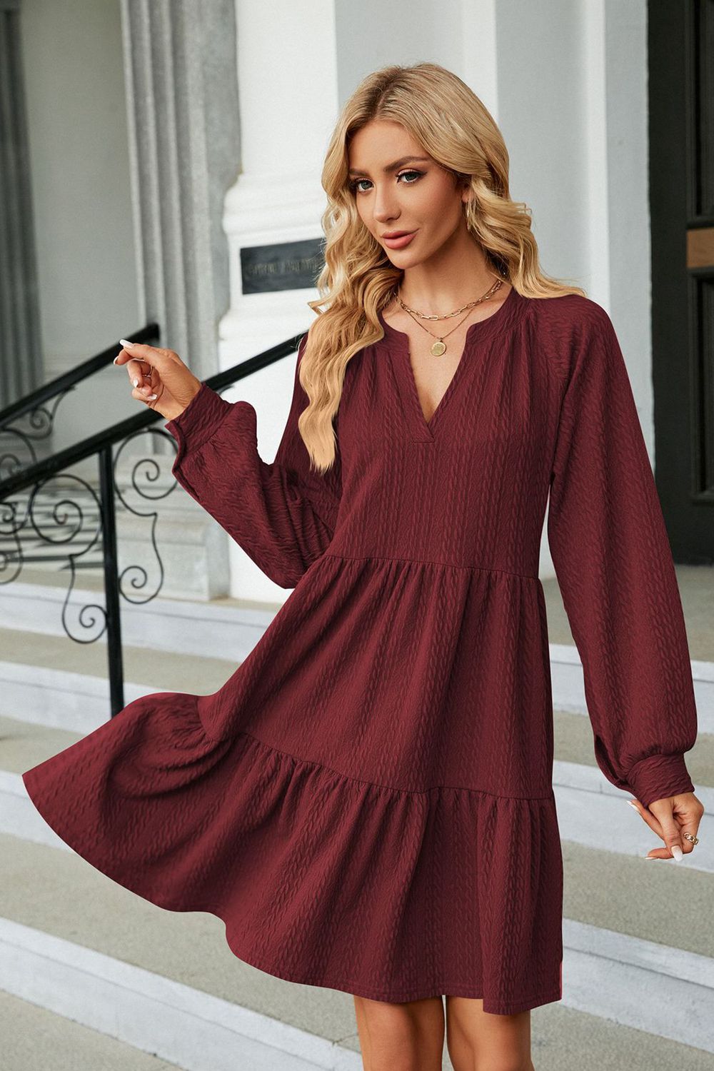 Burgundy notched neck long sleeve mini dress on model