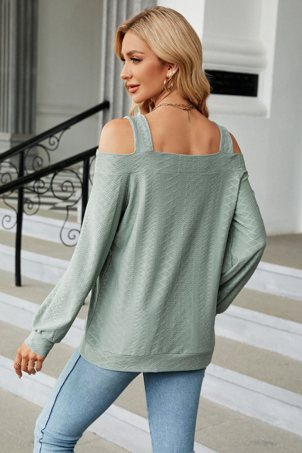 Square neck blouse with shoulder cutouts on model