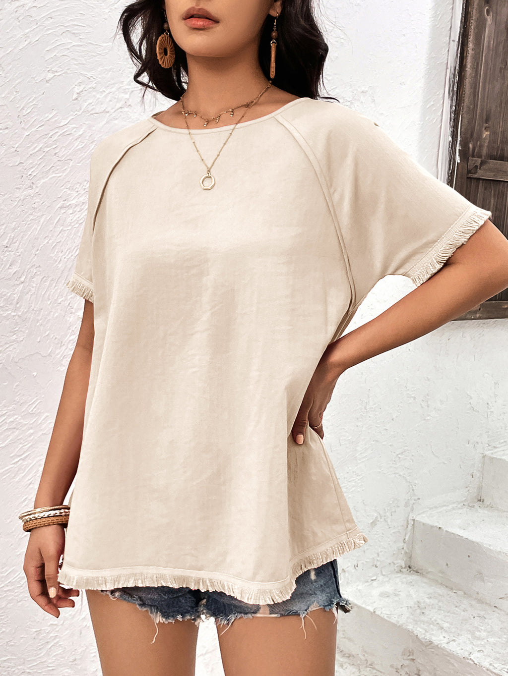 Cream fringe trim raglan sleeve top front view on model