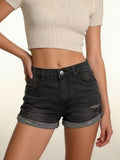Women’s distressed denim roll-up shorts on model, image 1
