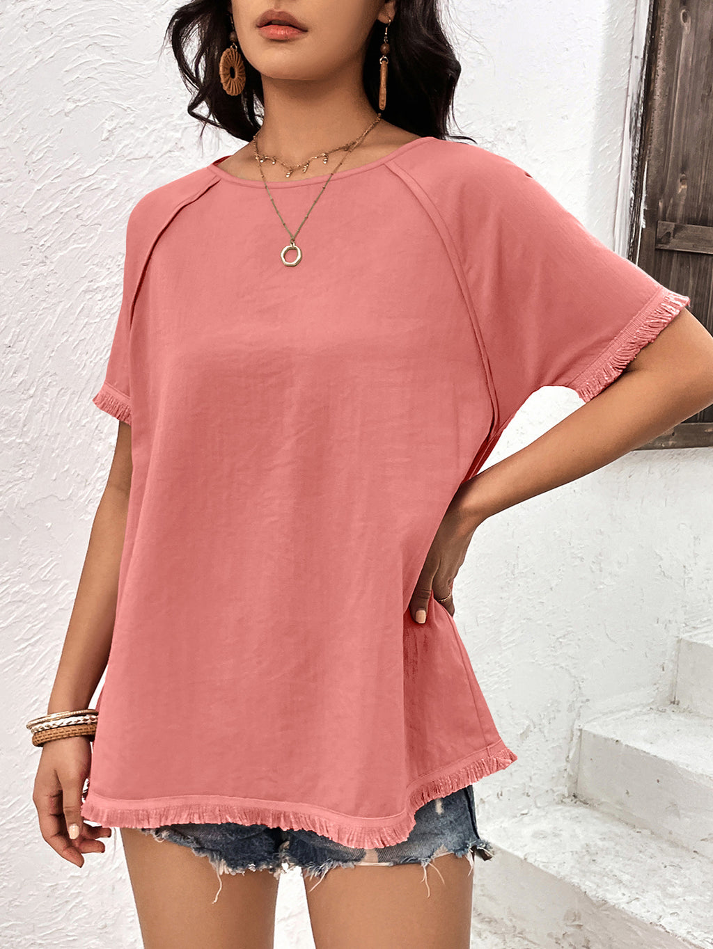 Coral longline raglan sleeve top side view on model