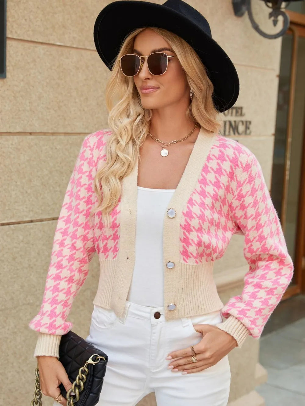 Pink houndstooth button-up long sleeve cardigan on model