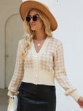 Tan houndstooth button-up long sleeve cardigan on model