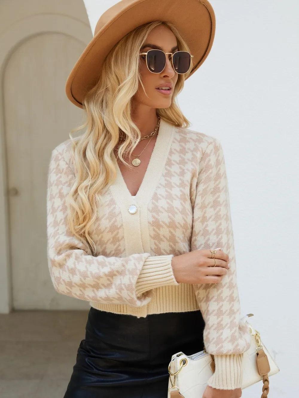 Tan houndstooth button-up long sleeve cardigan on model