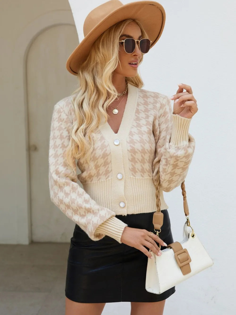Tan houndstooth button-up long sleeve cardigan on model