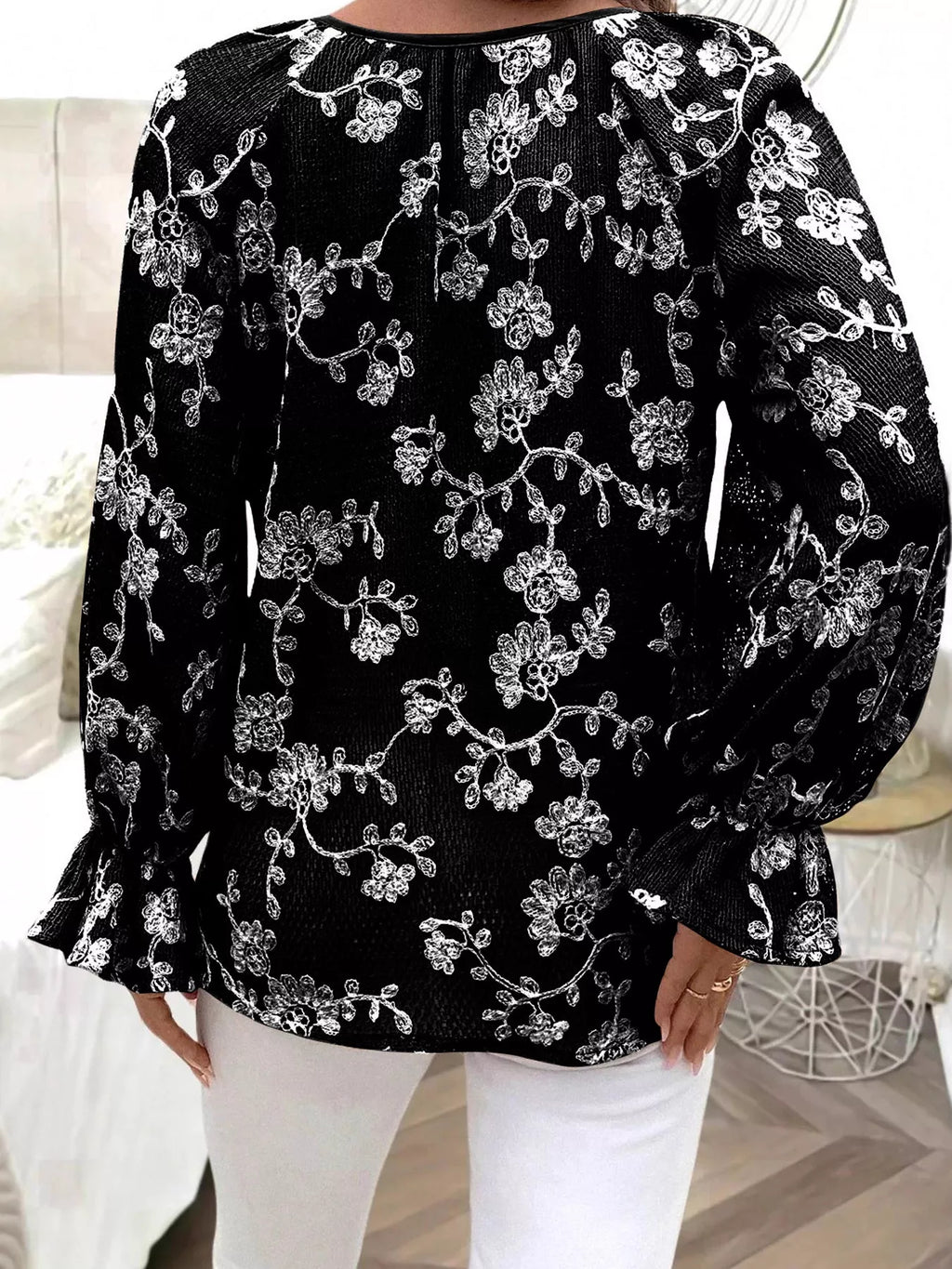 Women’s black embroidered blouse with tie neckline and button detail