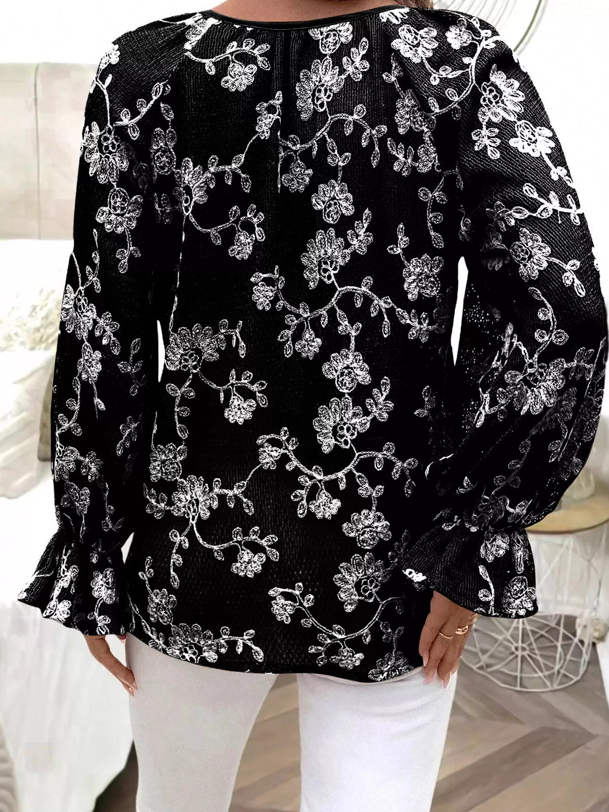 Women’s black embroidered blouse with tie neckline and button detail