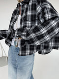 Black and white plaid button-up shirt with oversized fit