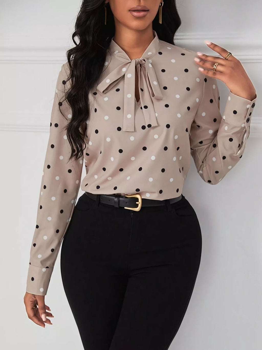 Women’s neutral polka dot tie-neck blouse styled with black pants